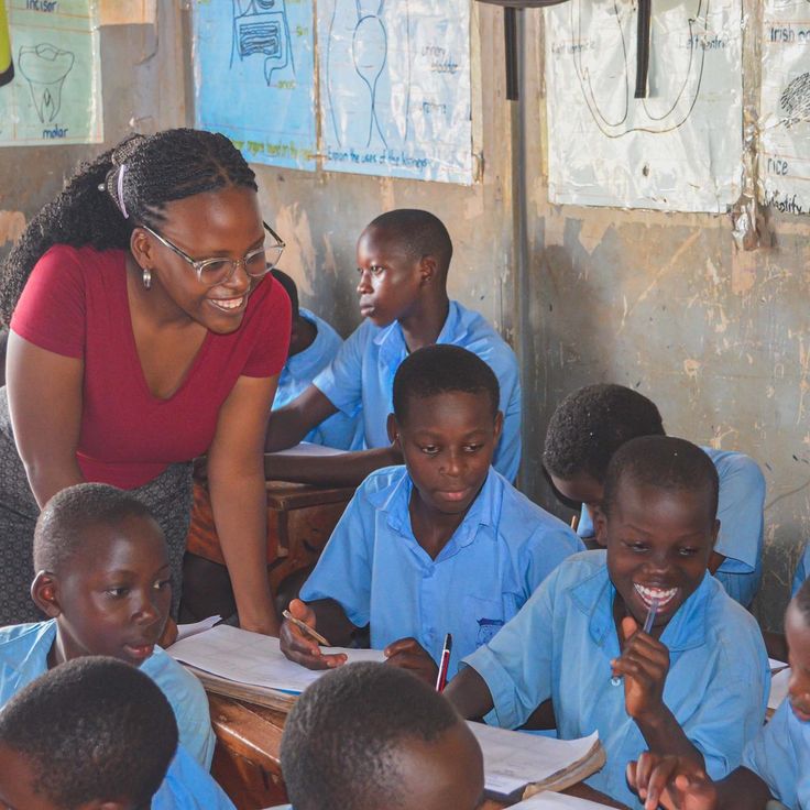 An African teacher helping a student with schoolwork